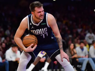 Jan 12, 2023; Los Angeles, California, USA; Dallas Mavericks guard Luka Doncic (77) gets the rebound against the Los Angeles Lakers during the second half at Crypto.com Arena. Mandatory Credit: Gary A. Vasquez-USA TODAY Sports