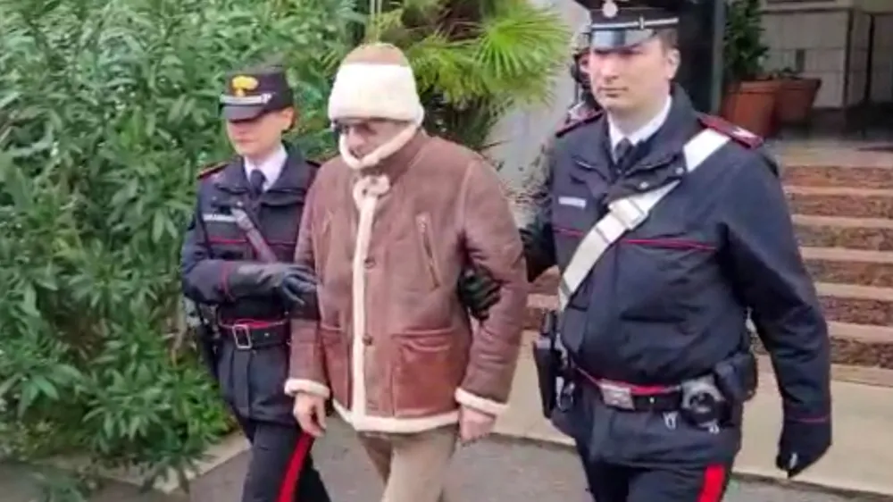 A screengrab taken from a video shows Matteo Messina Denaro the country's most wanted mafia boss being escorted out of a Carabinieri police station after he was arrested in Palermo, Italy, January 16, 2023. Carabinieri/Handout via REUTERS ATTENTION EDITORS THIS IMAGE HAS BEEN SUPPLIED BY A THIRD PARTY.