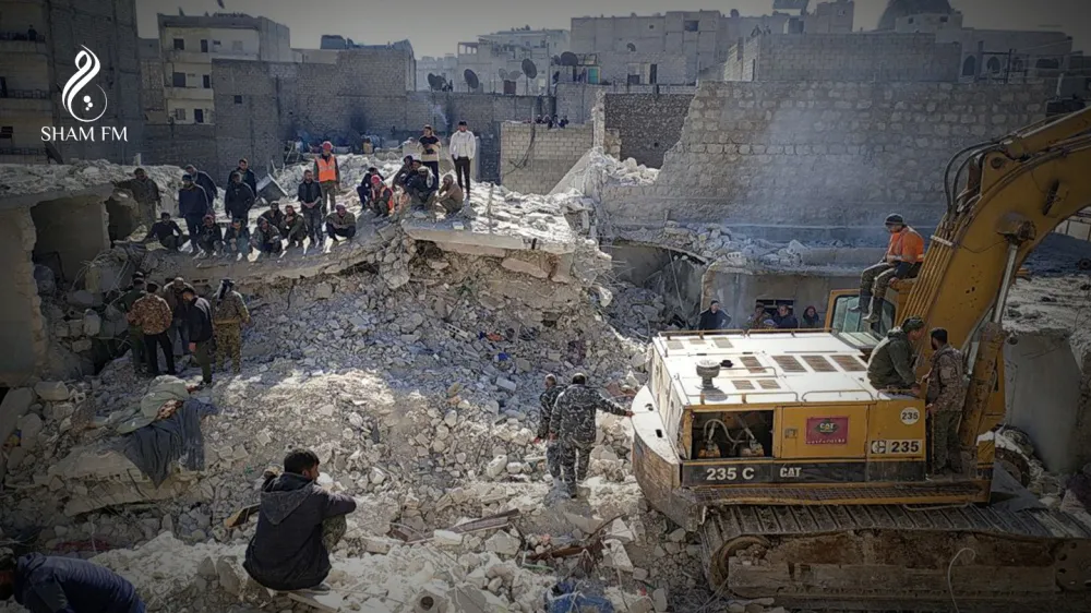 Members of a rescue team work on the scene of a residential building collapse in the Sheikh Maksoud neighbourhood of Aleppo, Syria January 22, 2023. SHAM FM/Handout via REUTERS THIS IMAGE HAS BEEN SUPPLIED BY A THIRD PARTY. MANDATORY CREDIT