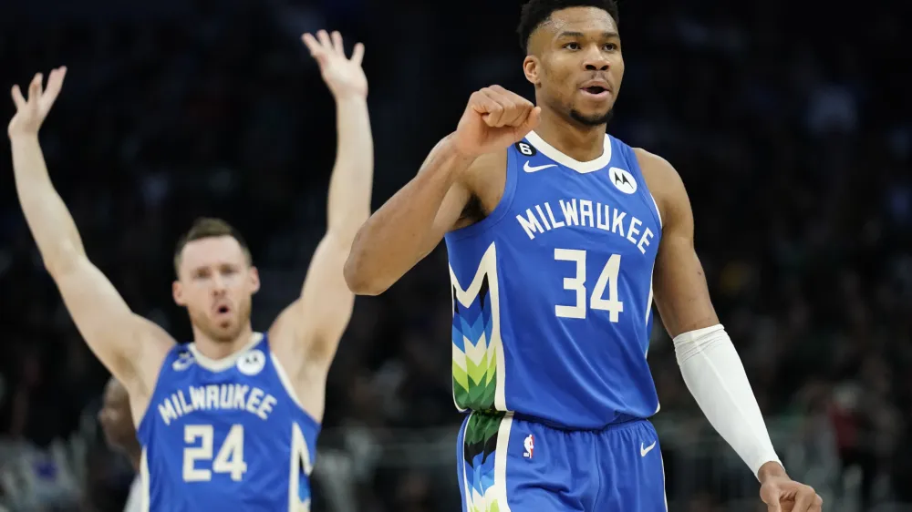 Milwaukee Bucks' Giannis Antetokounmpo (34) and Pat Connaughton (24) celebrate during the second half of the team's NBA basketball game against the Orlando Magic on Wednesday, March 1, 2023, in Milwaukee. (AP Photo/Aaron Gash)