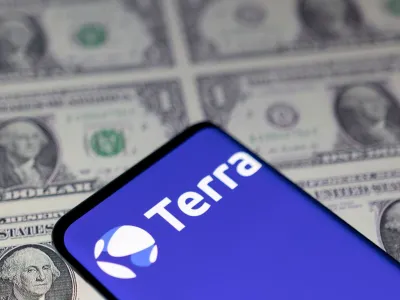 FILE PHOTO: Smartphone with Terra logo is placed on displayed U.S. dollars in this illustration taken May 11, 2022. REUTERS/Dado Ruvic/Illustration/File Photo