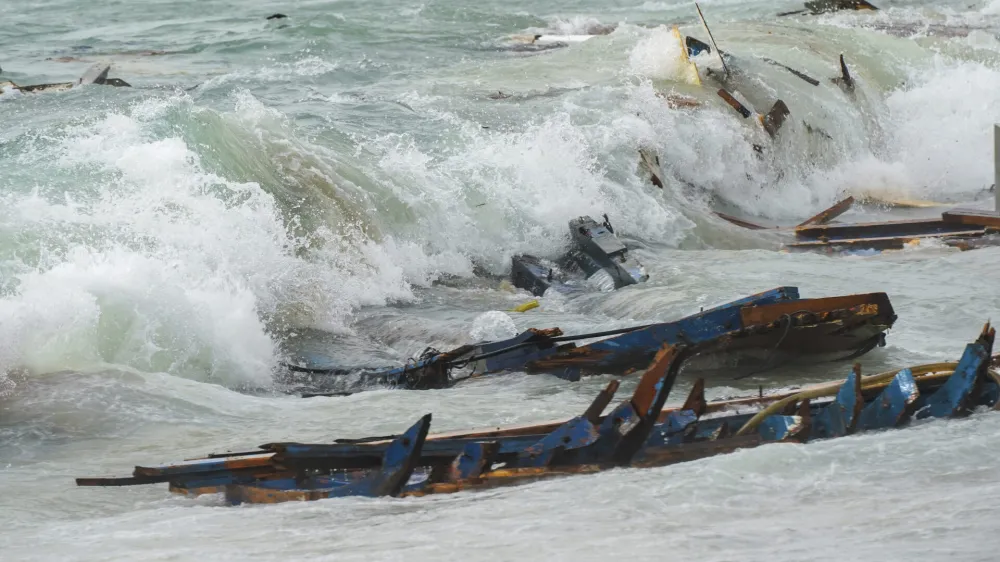 The wreckage from a capsized boat washes ashore at a beach near Cutro, southern Italy, Sunday, Feb. 26, 2023. Rescue officials say an undetermined number of migrants have died and dozens have been rescued after their boat broke apart off southern Italy. (Antonino Durso/LaPresse via AP)