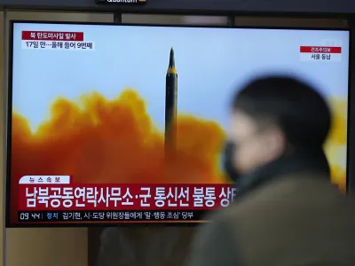 A TV screen is seen reporting North Korea's missile launch with file footage during a news program at the Seoul Railway Station in Seoul, South Korea, Thursday, April 13, 2023. North Korea launched a ballistic missile that landed in the waters between the Korean Peninsula and Japan on Thursday, prompting Japan to order residents on an island to take shelter as a precaution. The order has been lifted. (AP Photo/Lee Jin-man)