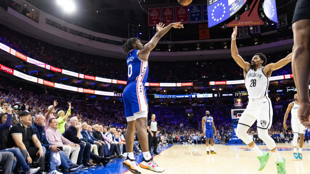 Apr 17, 2023; Philadelphia, Pennsylvania, USA; Philadelphia 76ers guard Tyrese Maxey (0) scores a three pointer in front of Brooklyn Nets guard Spencer Dinwiddie (26) during the fourth quarter in game two of the 2023 NBA playoffs at Wells Fargo Center. Mandatory Credit: Bill Streicher-USA TODAY Sports