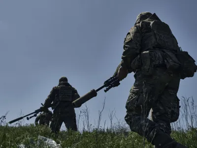 Ukrainian army snipers change their position facing Russian troops near Bakhmut, Donetsk region, Ukraine, Tuesday, May 2, 2023. (AP Photo/Libkos)