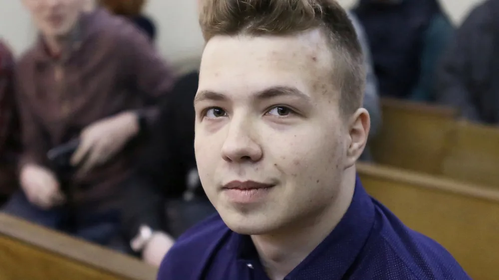 FILE PHOTO: Opposition blogger and activist Roman Protasevich, who is accused of participating in an unsanctioned protest at the Kuropaty preserve, waits before the beginning of a court hearing in Minsk, Belarus April 10, 2017. REUTERS/Stringer/File Photo