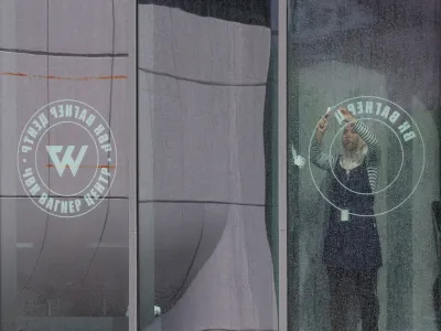 A staff removes logo on a window of the "PMC Wagner Centre", associated with the founder of the Wagner Group, in Saint Petersburg, Russia July 1, 2023. REUTERS/Anton Vaganov