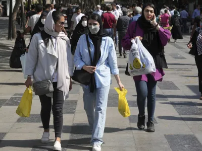 FILE - Women shop in the old main bazaar of Tehran, Iran, Saturday, Oct. 1, 2022. Iranian police have announced a new campaign to force women to wear the Islamic headscarf. Morality police returned to the streets on Sunday, 10 months after the death of a woman in their custody sparked nationwide protests. (AP Photo/Vahid Salemi, File)