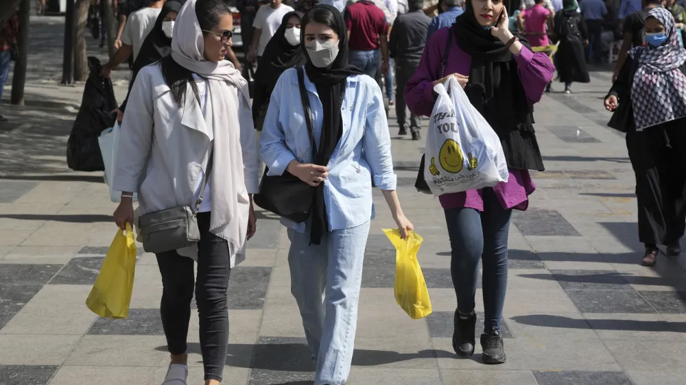 FILE - Women shop in the old main bazaar of Tehran, Iran, Saturday, Oct. 1, 2022. Iranian police have announced a new campaign to force women to wear the Islamic headscarf. Morality police returned to the streets on Sunday, 10 months after the death of a woman in their custody sparked nationwide protests. (AP Photo/Vahid Salemi, File)