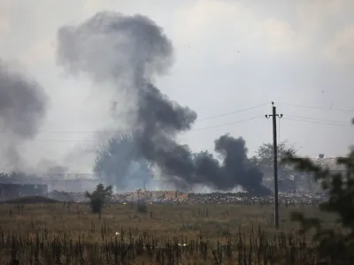 FILE - Smoke rises over the site of explosion at an ammunition storage of the Russian army near the village of Mayskoye, Crimea, Tuesday, Aug. 16, 2022. A spate of drone attacks that Russian authorities blamed on Ukraine has targeted areas in southern and western Russia, reflecting the Ukrainian military's growing reach as the war dragged into a second year. (AP Photo, File)