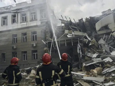 Emergency service personnel work at the site of a destroyed building after a Russian attack in Odesa, Ukraine, Thursday, July 20, 2023. (AP Photo/Libkos)