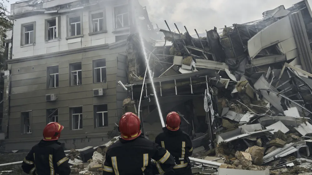 Emergency service personnel work at the site of a destroyed building after a Russian attack in Odesa, Ukraine, Thursday, July 20, 2023. (AP Photo/Libkos)