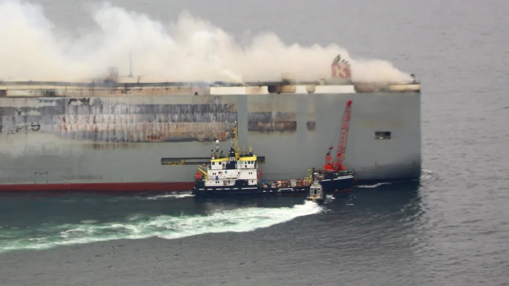 Smoke rises from burning cargo ship Fremantle Highway at sea off the Netherlands, July 28, 2023. Dutch Coastguard/Handout via REUTERS THIS IMAGE HAS BEEN SUPPLIED BY A THIRD PARTY MANDATORY CREDIT NO RESALES. NO ARCHIVES.