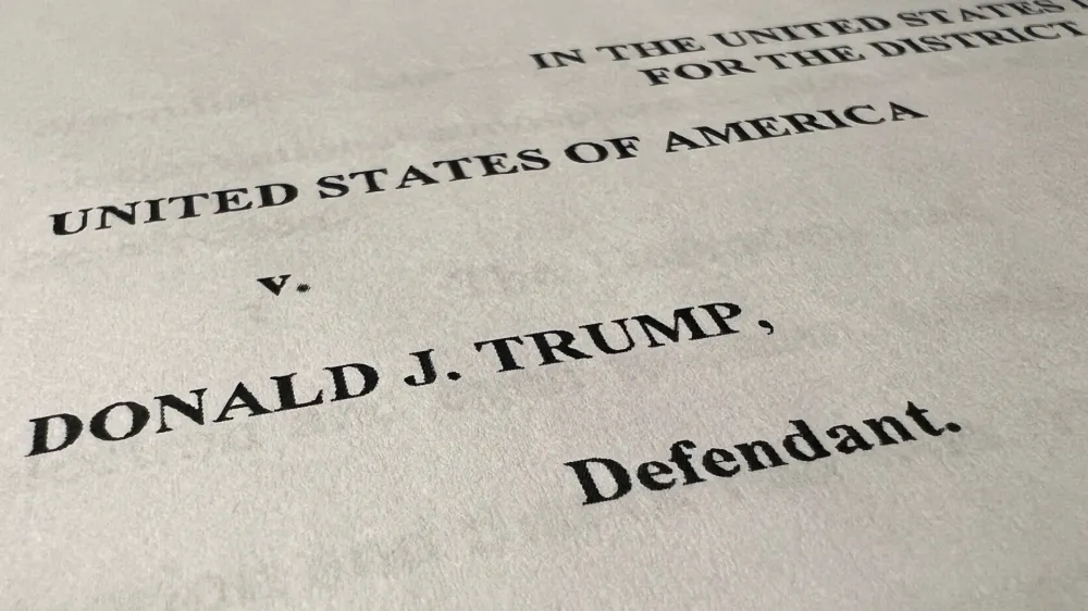 The opening page of an indictment against former U.S. President Donald Trump is seen after he was hit with criminal charges for a third time in four months - this time arising from efforts to overturn his 2020 U.S. election defeat, in a photo illustration August 1, 2023. REUTERS/Kevin Fogarty/Photo Illustration