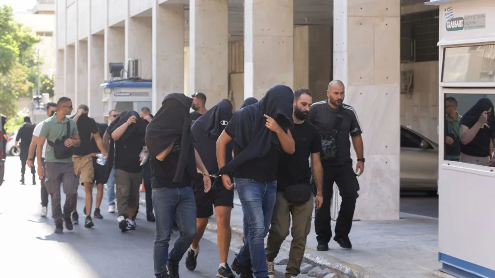 Soccer fans detained following violent clashes between AEK Athens and Dinamo Zagreb soccer fans, that lead to the death of a man, are taken to a magistrate, in Athens, Greece, August 11, 2023. REUTERS/Louiza Vradi