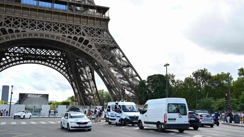 12 August 2023, France, Paris: Officers of the riot police (CRS) secure an area in the center of Paris after a security alert because a bomb threat resulted in the evacuation of three floors of the Eiffel Tower. About 4,000 people had to leave the landmark and the forecourt on Saturday, police sources told Deutsche Presse-Agentur. Photo: Miguel Medina/AFP/dpa