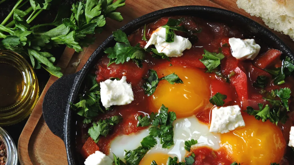 ﻿Fried eggs with vegetables and feta cheese. Shakshuka. Keto diet. Keto breakfast or snack. Middle Eastern style.