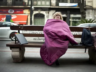 Marta Uriarte wraps herself up in a sleeping bag at the beginning of her hunger strike in protest against her forthcoming eviction, after failing to pay the mortgage on her house, in front of the Bilbao Bizkaia Kutxa (BBK) bank in central Bilbao, in this file picture taken March 5, 2012. Spanish banks will learn from an audit on September 28, 2012, the extent of the damage from the collapse of a real estate boom that left the sector with 184 billion euros in repossessions and bad loans. REUTERS/Vincent West/Files (SPAIN - Tags: BUSINESS CIVIL UNREST SOCIETY POVERTY REAL ESTATE)