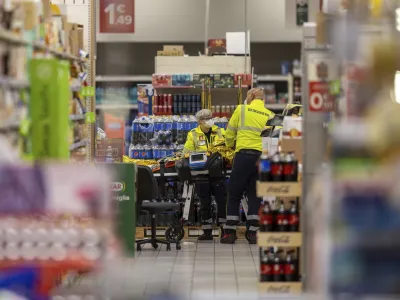 Emergency personnel attend to a scene of an attack in Milan, Italy, Thursday Oct. 27, 2022. A man armed with a knife stabbed five people inside a shopping center south of Milan on Thursday. (LaPresse via AP)