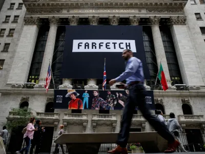 FILE PHOTO: A banner to celebrate the IPO of online fashion house Farfetch is displayed on the facade of the of the New York Stock Exchange (NYSE) in New York, U.S., September 21, 2018. REUTERS/Brendan McDermid/File Photo