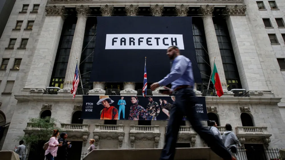 FILE PHOTO: A banner to celebrate the IPO of online fashion house Farfetch is displayed on the facade of the of the New York Stock Exchange (NYSE) in New York, U.S., September 21, 2018. REUTERS/Brendan McDermid/File Photo