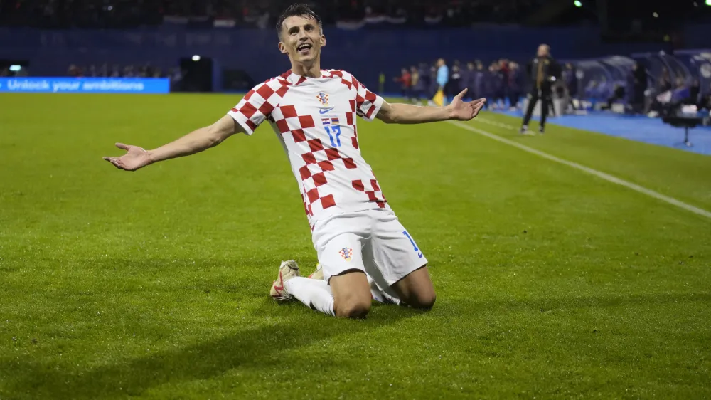 Croatia's Ante Budimir celebrates after scoring against Armenia during the Euro 2024 group D qualifying soccer match between Croatia and Armenia at the Maksimir Stadium in Zagreb, Croatia, Tuesday, Nov. 21, 2023. (AP Photo/Darko Bandic)