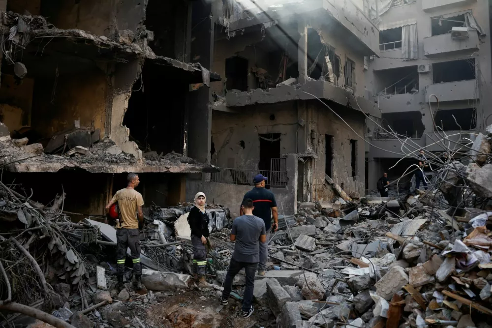 People inspect the site of an Israeli air strike, amid ongoing hostilities between Hezbollah and Israeli forces, in Beirut, Lebanon, October 11, 2024. REUTERS/Louisa Gouliamaki