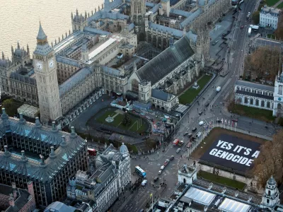 Cars drive past a banner put up by the protest group Led by Donkeys, quoting Israeli Holocaust professor Amos Goldberg's statement with regards to the Israel-Hamas conflict, in Parliament Square, London, Britain, December 4, 2024. Led by Donkeys/Handout via REUTERS THIS IMAGE HAS BEEN SUPPLIED BY A THIRD PARTY. MANDATORY CREDIT