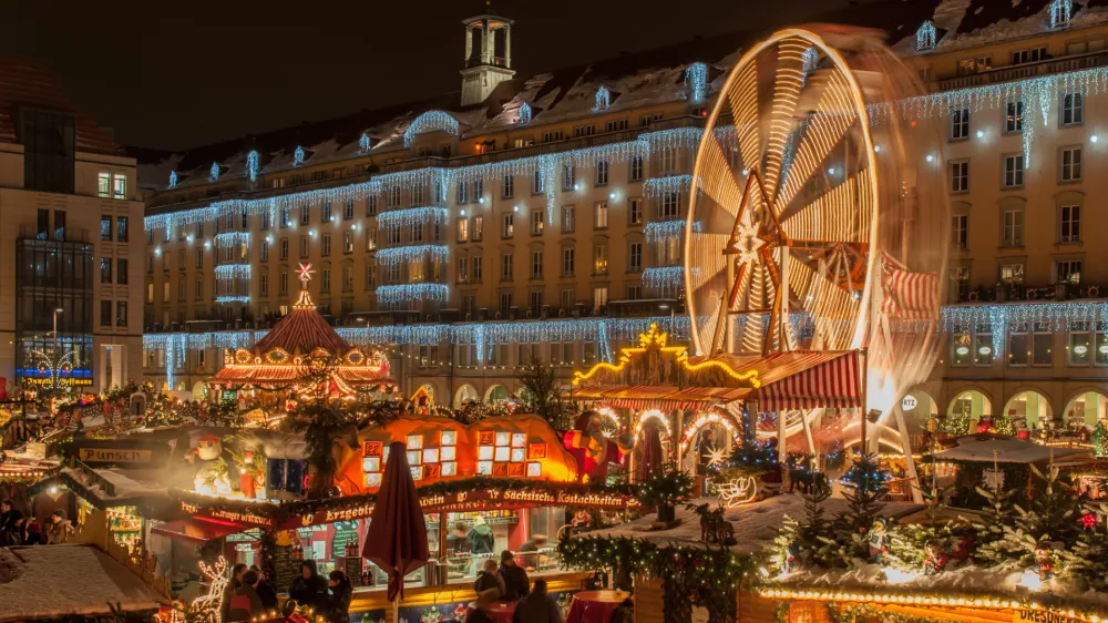 Dresden, Germany - December 20, 2010: An unidentified group of people enjoy Christmas market in Dresden on December 20, 2010 in Dresden, Germany. It is Germany's oldest Christmas Market with a very long history dating back to 1434.