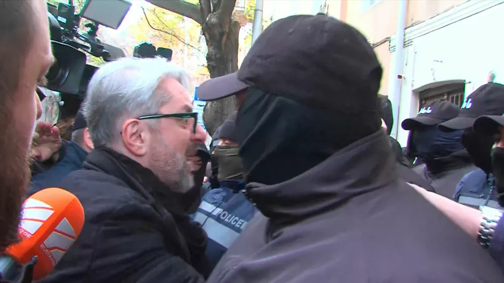 Nika Gvaramia, leader of the Coalition for Change party, is seen surrounded by police officers before his detention in Tbilisi, Georgia December 4, 2024, in this still image from video. Formula TV/Handout via REUTERS ATTENTION EDITORS - THIS IMAGE HAS BEEN SUPPLIED BY A THIRD PARTY. NO RESALES. NO ARCHIVES. MANDATORY CREDIT. GEORGIA OUT. NO COMMERCIAL OR EDITORIAL SALES IN GEORGIA.