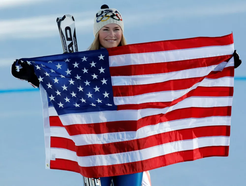 FILE PHOTO: Lindsey Vonn holds a U.S flag after winning the gold medal in the women's Alpine Skiing Downhill race at the Vancouver 2010 Winter Olympics in Whistler, British Columbia February 17, 2010.  REUTERS/Mike Segar/File Photo