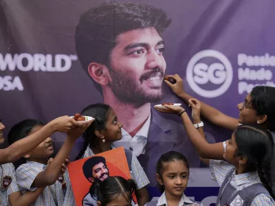 Students at Gukesh Dommaraju's school in Chennai celebrate after Gukesh became the youngest World Chess Champion, in Chennai, India, Friday, Dec. 13, 2024. (AP Photo/Mahesh Kumar A.)