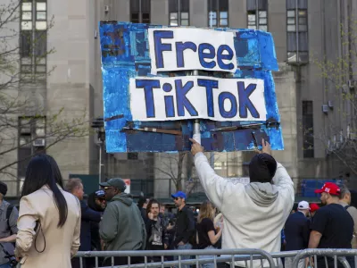 FILE - A man carries a Free TikTok sign in front of the courthouse where the hush-money trial of Donald Trump was underway on April 15, 2024, in New York. (AP Photo/Ted Shaffrey, File)