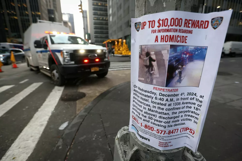 A poster is attached to a lamp post outside the Hilton hotel near the scene where the CEO of UnitedHealthcare Brian Thompson was shot dead in Midtown Manhattan, in New York City, U.S., December 5, 2024. REUTERS/Mike Segar