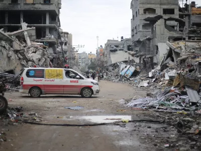 FILED - 29 November 2023, Palestinian Territories, Beit Lahia: An ambulance drives through the ruins of Beit Lahia following an Israeli airstrike. At least 10 people have died in attacks mounted by the Israeli military in the Gaza Strip, the Hamas-controlled Health Ministry said on Wednesday. Photo: Mohammed Alaswad/APA Images via ZUMA Press Wire/dpa