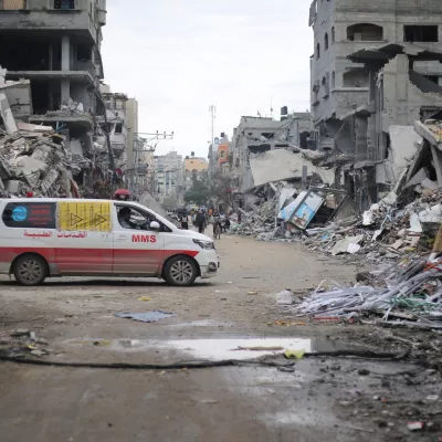 FILED - 29 November 2023, Palestinian Territories, Beit Lahia: An ambulance drives through the ruins of Beit Lahia following an Israeli airstrike. At least 10 people have died in attacks mounted by the Israeli military in the Gaza Strip, the Hamas-controlled Health Ministry said on Wednesday. Photo: Mohammed Alaswad/APA Images via ZUMA Press Wire/dpa