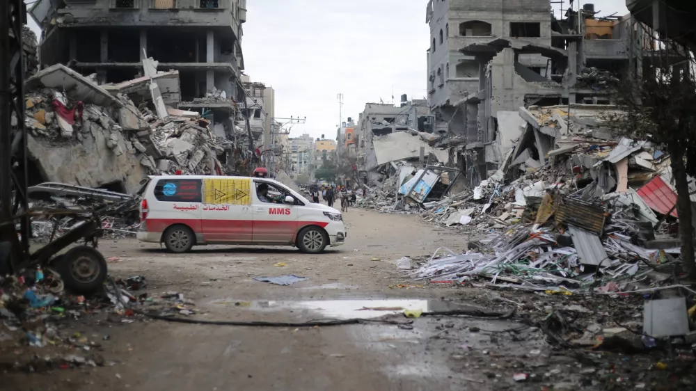 FILED - 29 November 2023, Palestinian Territories, Beit Lahia: An ambulance drives through the ruins of Beit Lahia following an Israeli airstrike. At least 10 people have died in attacks mounted by the Israeli military in the Gaza Strip, the Hamas-controlled Health Ministry said on Wednesday. Photo: Mohammed Alaswad/APA Images via ZUMA Press Wire/dpa