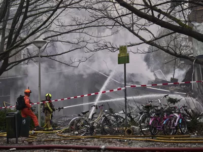 Firefighters work at the sight of an explosion at an apartment block in The Hague, Saturday, Dec. 7, 2024. (AP Photo/Phil Nijhuis)