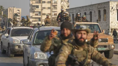 Syrian opposition fighters ride along the streets in the aftermath of the opposition's takeover of Hama, Syria, Friday, Dec. 6, 2024. (AP Photo/Ghaith Alsayed)