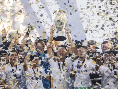 07 December 2024, US, Los Angeles: LA Galaxy's Maya Yoshida and teammates celebrate with the trophy after the Final of the Audi 2024 MLS Cup match between the LA Galaxy and the New York Red Bulls at Dignity Health Sports Park Stadium in Carson, California. Photo: Douglas Cuellar/PI via ZUMA Press Wire/dpa