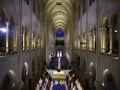 Guests attend an inaugural Mass, with the consecration of the high altar, at the Notre-Dame de Paris Cathedral, five-and-a-half years after a fire ravaged the Gothic masterpiece, as part of ceremonies to mark the Cathedral's reopening after its restoration, in Paris, France, Sunday, Dec. 8, 2024. (Sarah Meyssonnier/Pool Photo via AP)