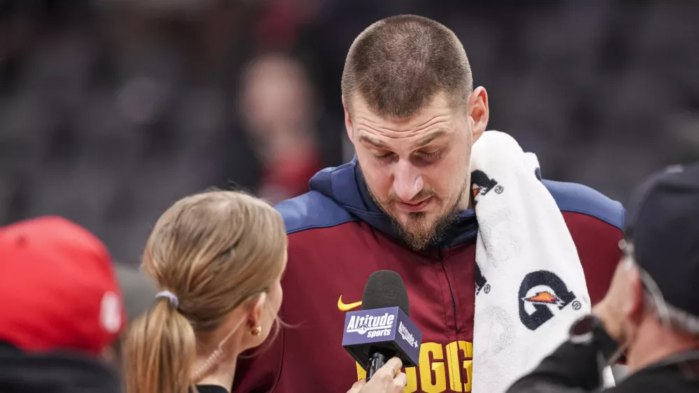 Dec 8, 2024; Atlanta, Georgia, USA; Denver Nuggets center Nikola Jokic (15) reacts while being interviewed after the game against the Atlanta Hawks during the second half at State Farm Arena. Mandatory Credit: Dale Zanine-Imagn Images