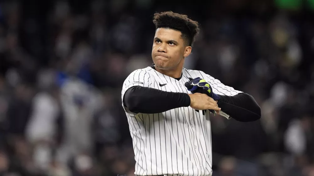 FILE - New York Yankees' Juan Soto takes off his batting gloves after grounding out against the New York Yankees to end the third inning in Game 3 of the baseball World Series, on Oct. 28, 2024, in New York. (AP Photo/Godofredo A. Vásquez, File)