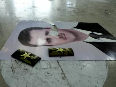 A damaged picture of Syria's Bashar al-Assad lies on the floor inside Qamishli international airport, after Syrian rebels announced that they have ousted Syria's Bashar al-Assad, in Qamishli, Syria December 9, 2024. REUTERS/Orhan Qereman