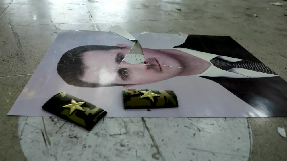 A damaged picture of Syria's Bashar al-Assad lies on the floor inside Qamishli international airport, after Syrian rebels announced that they have ousted Syria's Bashar al-Assad, in Qamishli, Syria December 9, 2024. REUTERS/Orhan Qereman