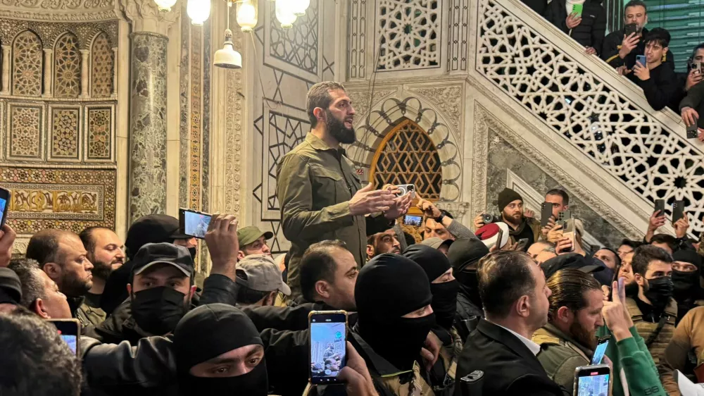 Top rebel commander Abu Mohammed al-Golani speaks to a crowd at Ummayad Mosque in Damascus, after Syrian rebels announced that they have ousted President Bashar al-Assad, Syria December 8, 2024. REUTERS/Mahmoud Hassano   TPX IMAGES OF THE DAY