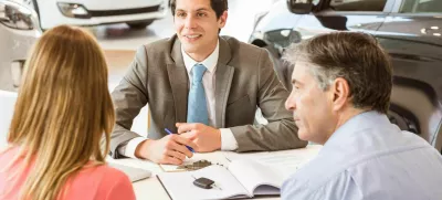 F5445N Smiling couple buying a new car