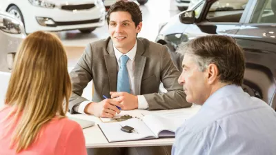 F5445N Smiling couple buying a new car