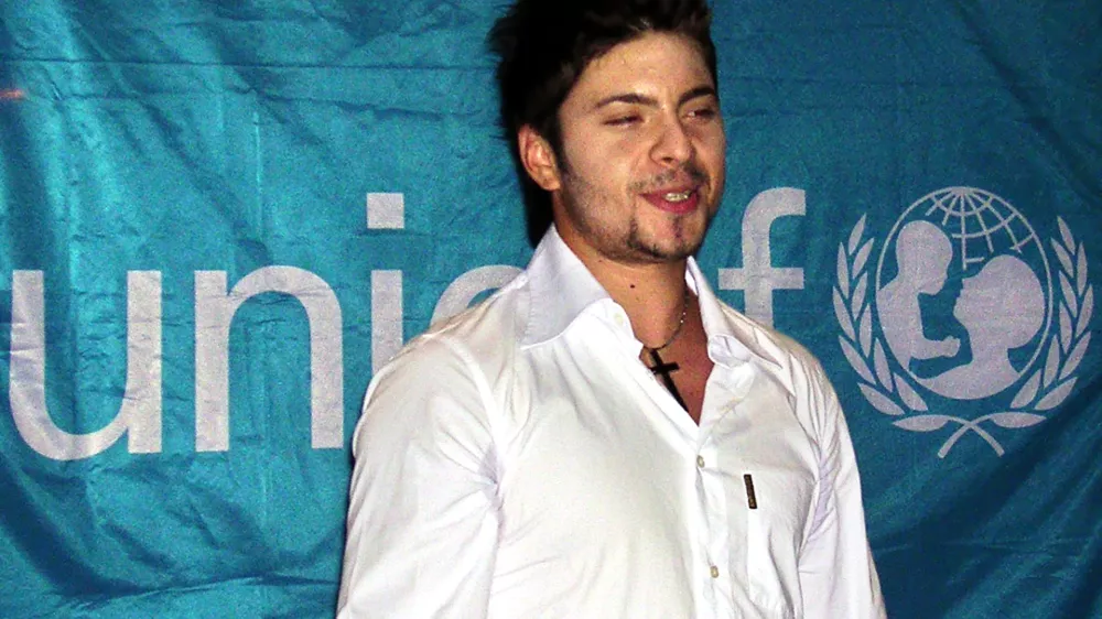 **FILE**Macedonian pop star Tose Proeski is seen by the UNICEF flag in Skopje, in this file photo from Aug. 31, 2004, the day when he becomes a regional goodwill ambassador for the UN agency for children, UNICEF.  26-year old Proeski was killed early Tuesday, Oct. 16, 2007, in a car crash at Nova Gradiska, 100 kilometres east of Zagreb, Croatia. (AP Photo)