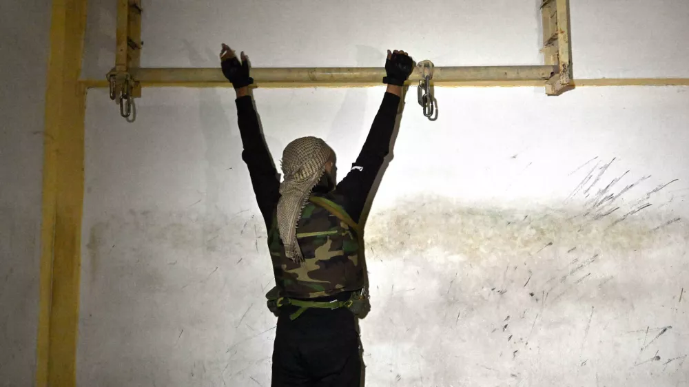 25 December 2024, Syria, Damascus: A soldier demonstrates how prisoners were tortured at the Syrian Military Intelligence Palestine Branch 235 that was a jail for political prisoners during a brutal regime where countless men disappeared in Damascus. Photo: Carol Guzy/ZUMA Press Wire/dpa